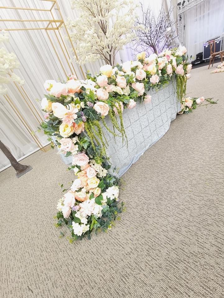 large white floral table runner at wedding