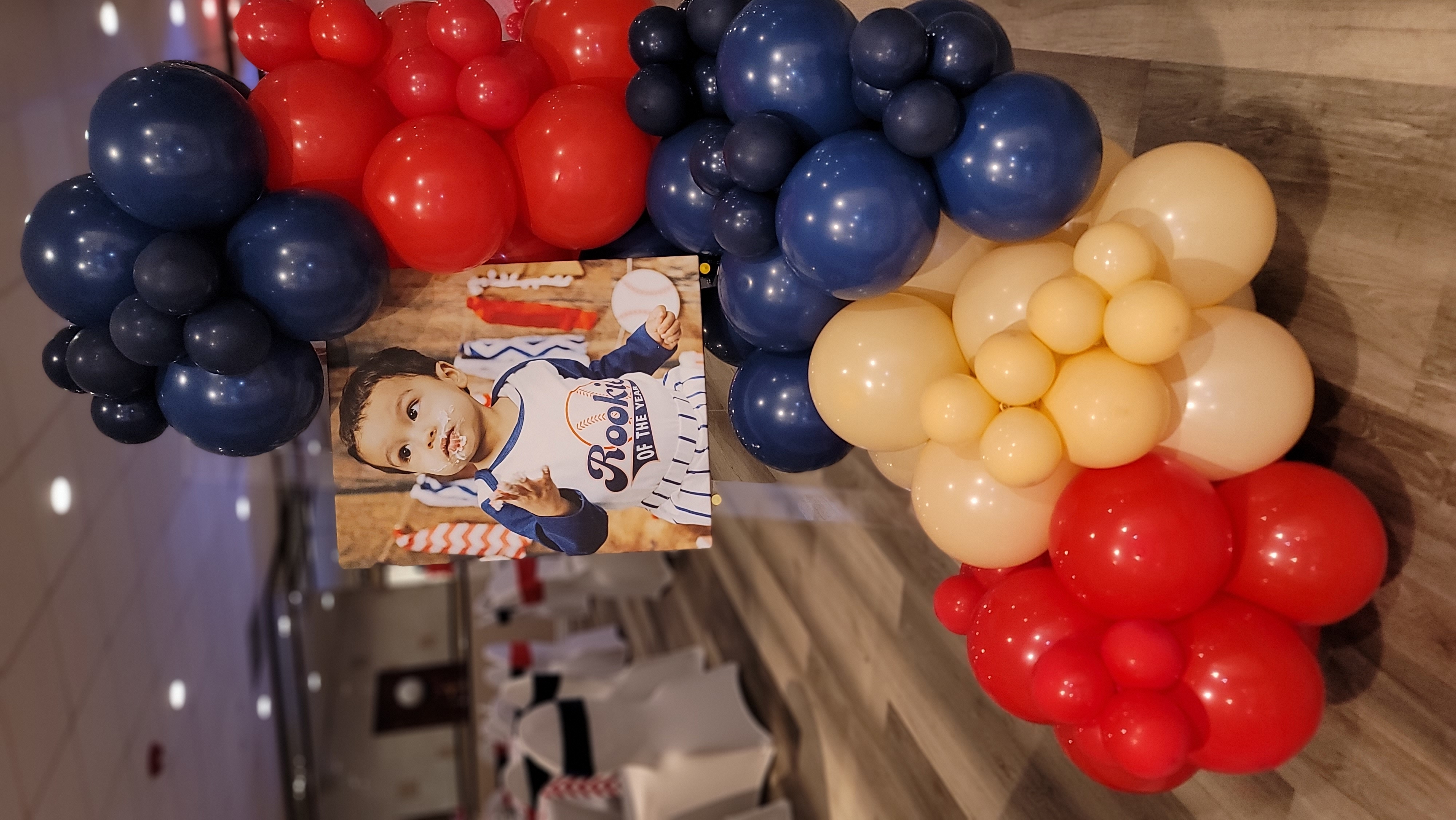 red, white, and blue baseball balloon column