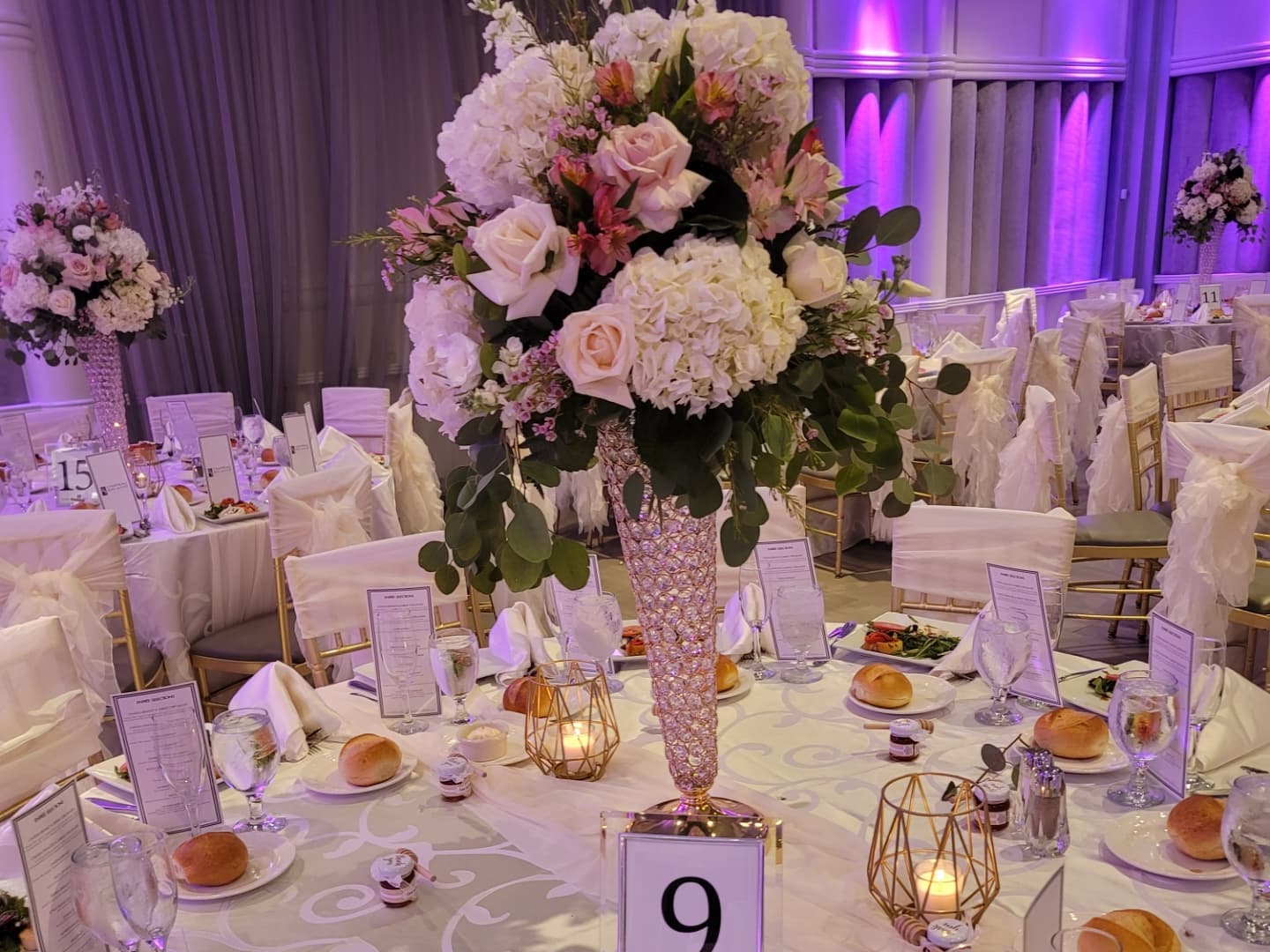 tall wedding reception centerpiece with roses and hydrangeas
