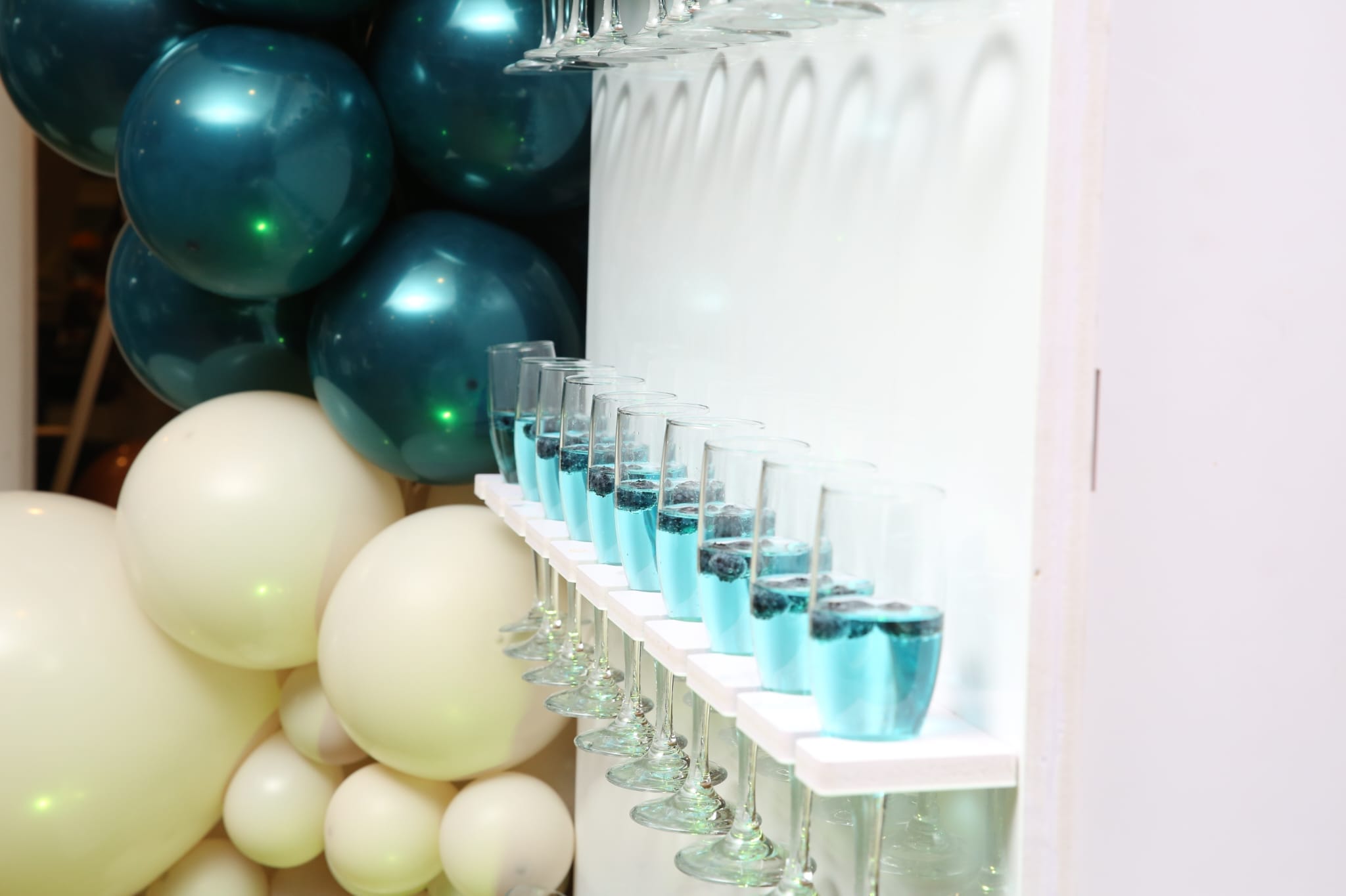 white and teal balloon column