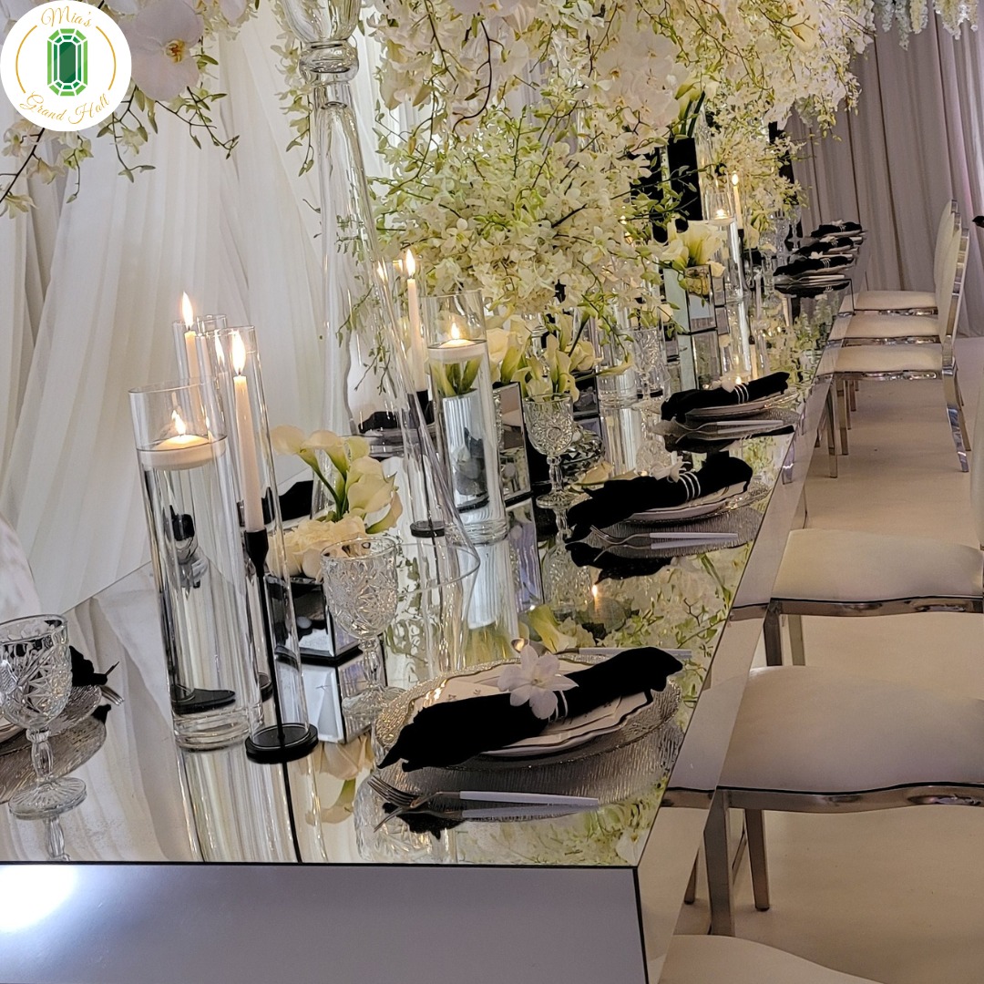 mirror table with black and white flowers and place settings