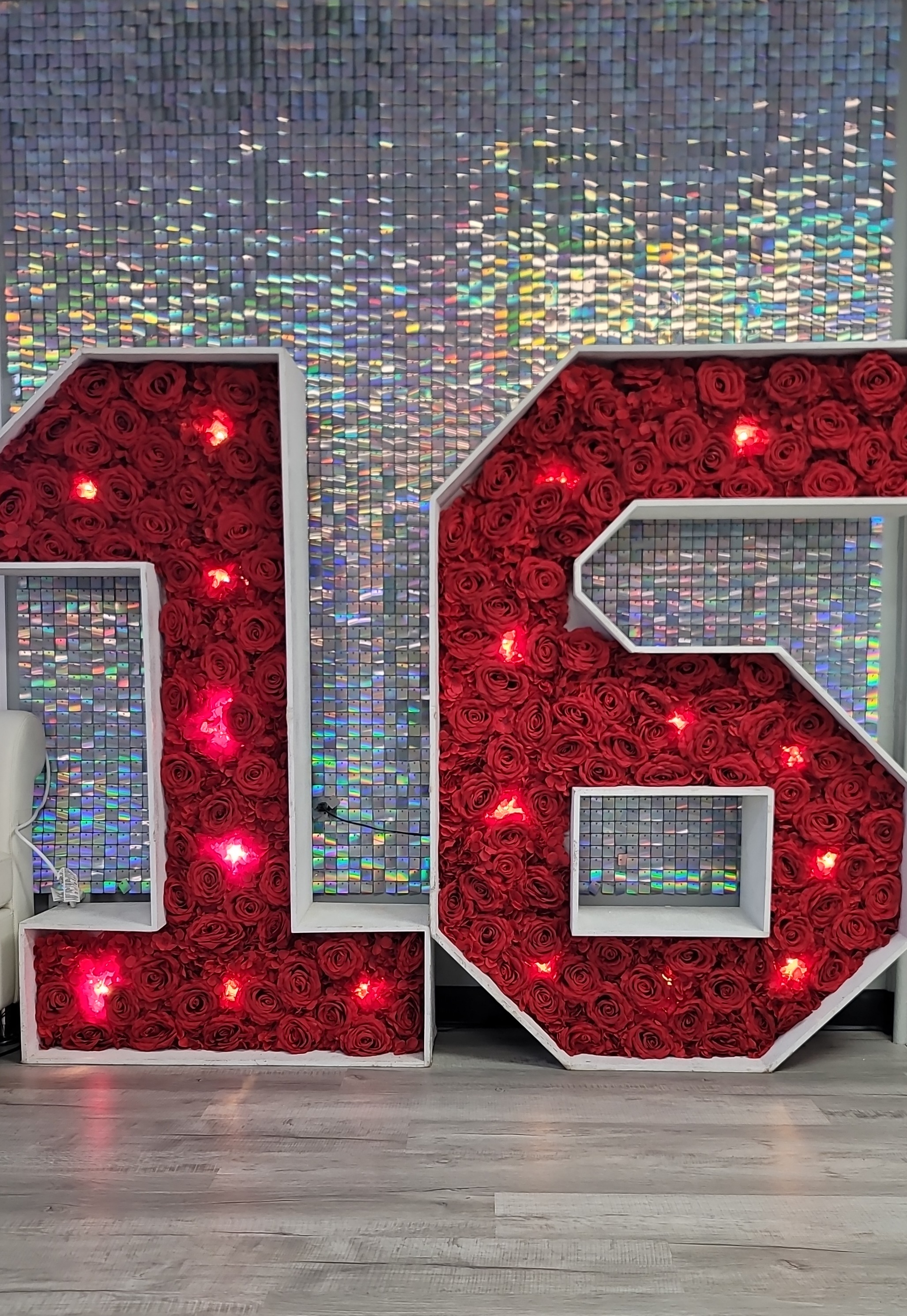 marquee numbers in front of glitter wall