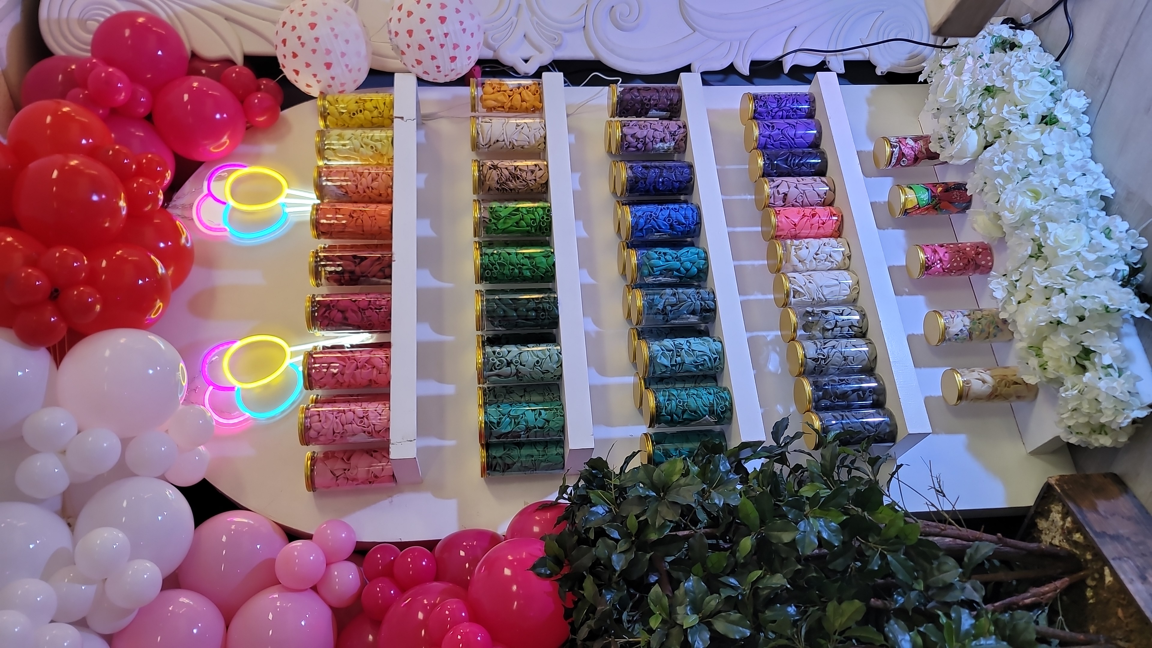 colorful balloons in jars on wall