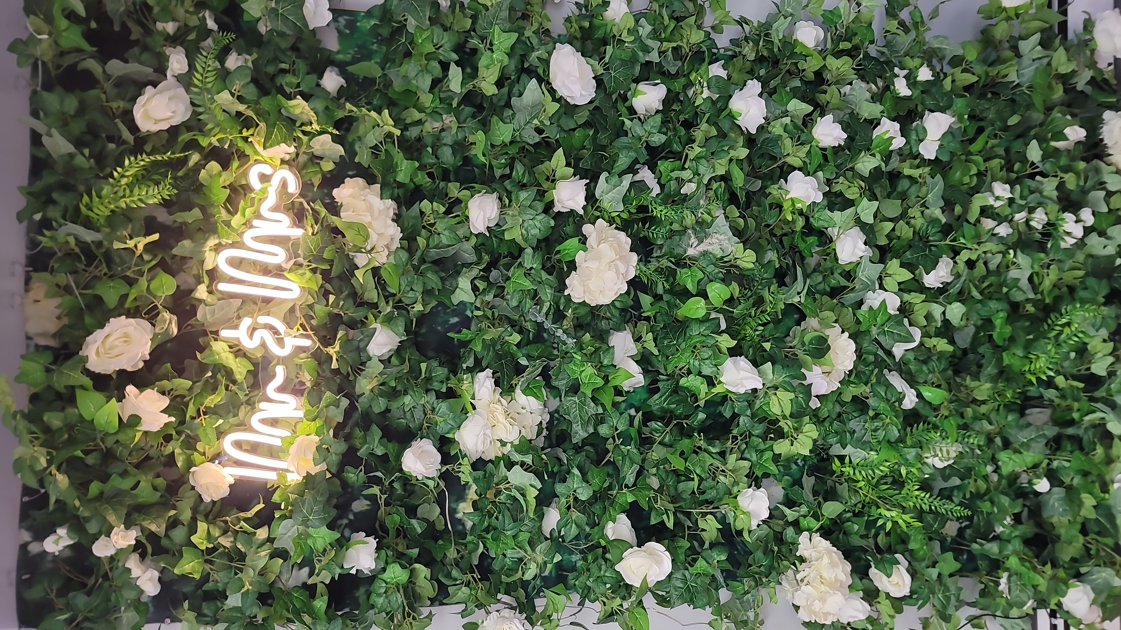 floral wall with mr and mrs neon light